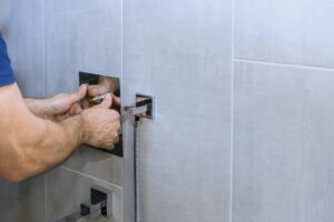 Home 13 Hands of person work on installing contemporary shower fixture in stylish bathroom detailed process of fixture installation.
