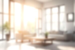 Blur living room at home with morning sunlight at big window for background usage. blur interior background concept. white, britht tone.